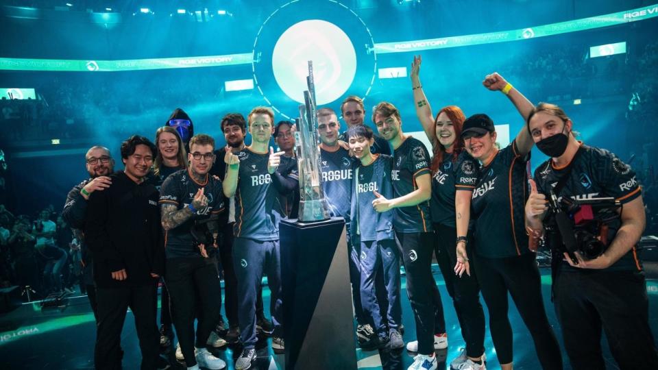 The Rogue Esports team stands around the LEC trophy