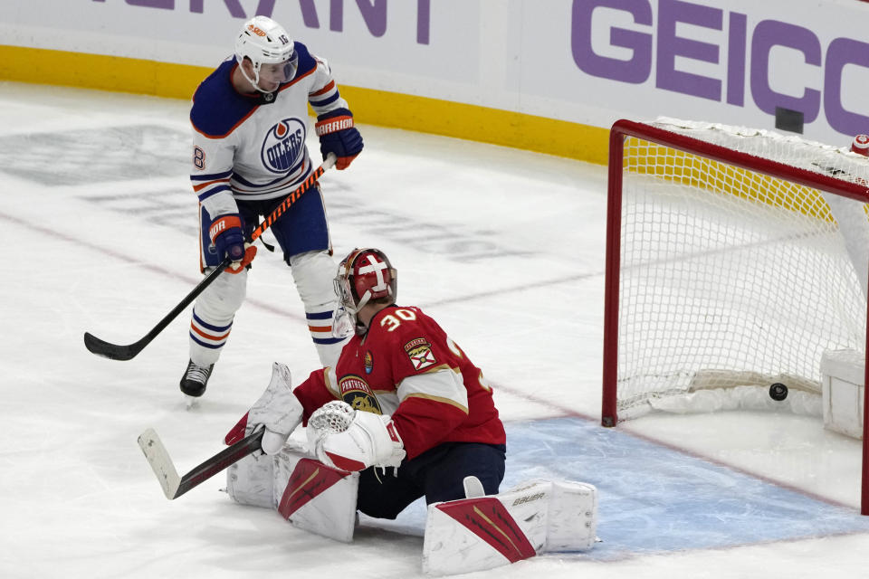 Edmonton Oilers left wing Zach Hyman (18) watches as the puck gets past Florida Panthers goaltender Spencer Knight (30) on a goal scored by Oilers defenseman Tyson Barrie during the third period of an NHL hockey game, Saturday, Nov. 12, 2022, in Sunrise, Fla. (AP Photo/Lynne Sladky)