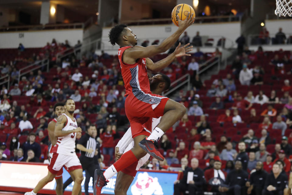 New Mexico's Jamal Mashburn Jr. drives to the basket, bumping into Fresno State's Destin Whitaker during the second half of an NCAA college basketball game in Fresno, Calif., Tuesday, Jan. 3, 2023. (AP Photo/Gary Kazanjian)