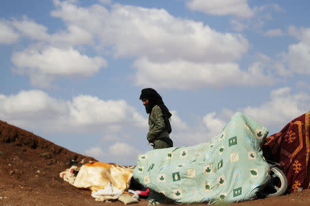 A rebel fighter from 'Jaysh al-Sunna' is seen standing in the southern Aleppo countryside, Syria June 10, 2016. REUTERS/Khalil Ashawi