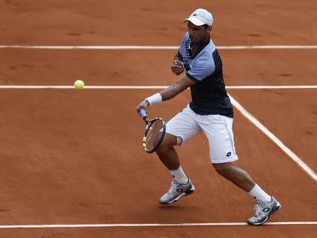 Alejandro Falla of Colombia plays a shot to Roger Federer of Switzerland during their men's singles match at the French Open tennis tournament at the Roland Garros stadium in Paris, France, May 24, 2015. REUTERS/Vincent Kessler