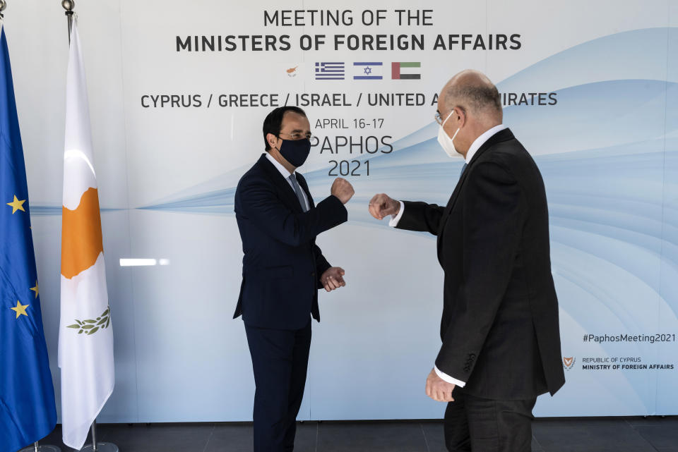 Cyprus' foreign minister Nicos Christodoulides, left, with his Greek counterpart Nikos Dendias before a meeting of the ministers of foreign affairs of Cyprus, Greece, Israel and United Arab of Emirates in city of Paphos, Cyprus, Friday, April 16, 2021. The event marks the first time the foreign ministers of all four countries have met following the recent normalization of relations between Israel and the United Arab Emirates and aims to expand cooperation to bolster regional stability. (Iakovos Hatzistavrou/Pool via AP)