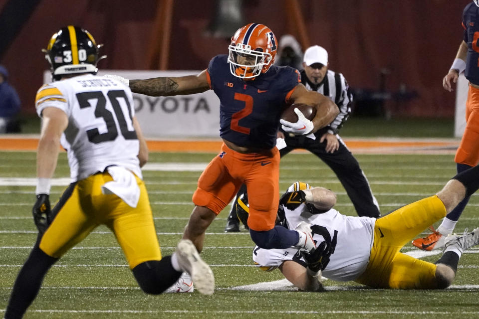 Illinois running back Chase Brown carries the ball during the second half of an NCAA college football game Saturday, Oct. 8, 2022, in Champaign, Ill. (AP Photo/Charles Rex Arbogast)