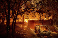 Flames consume a home as the Dixie Fire tears through the Indian Falls community in Plumas County, Calif., Saturday, July 24, 2021. The fire destroyed multiple residences in the area. (AP Photo/Noah Berger)