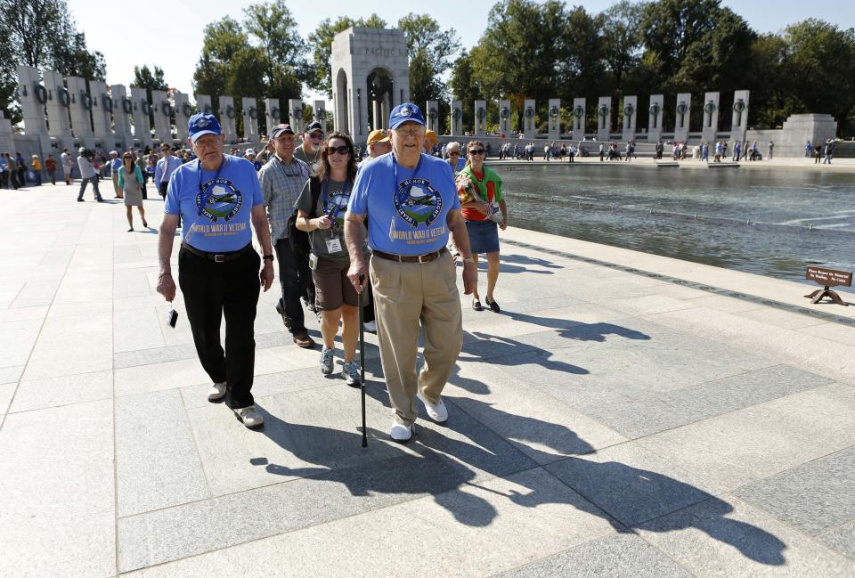 Veterans of the Heartland Honor Flight tour the World War Two Memorial in Washington October 2, 2013. The memorial is technically closed due to the government shutdown, but was opened today and yesterday for visiting veteran groups. REUTERS/Kevin Lamarque (UNITED STATES - Tags: POLITICS BUSINESS)