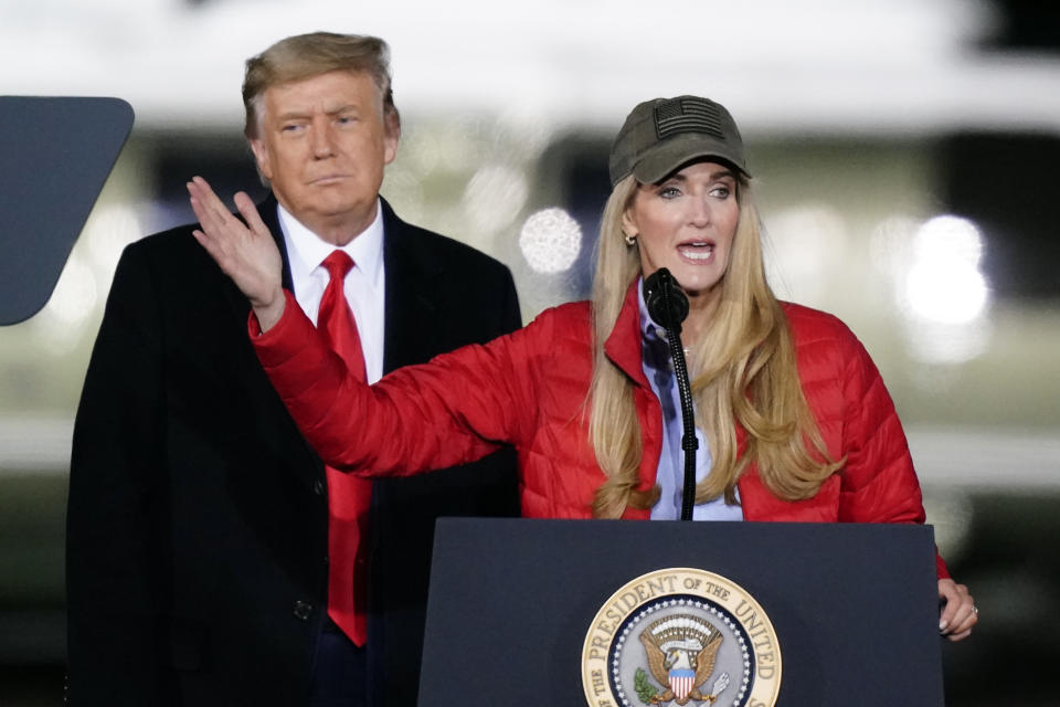 Sen. Kelly Loeffler, R-Ga., speaks as President Donald Trump listens during a campaign rally in support of Senate candidates Sen. Kelly Loeffler, R-Ga., and David Perdue in Dalton, Ga., Monday, Jan. 4, 2021. (AP Photo/Brynn Anderson)