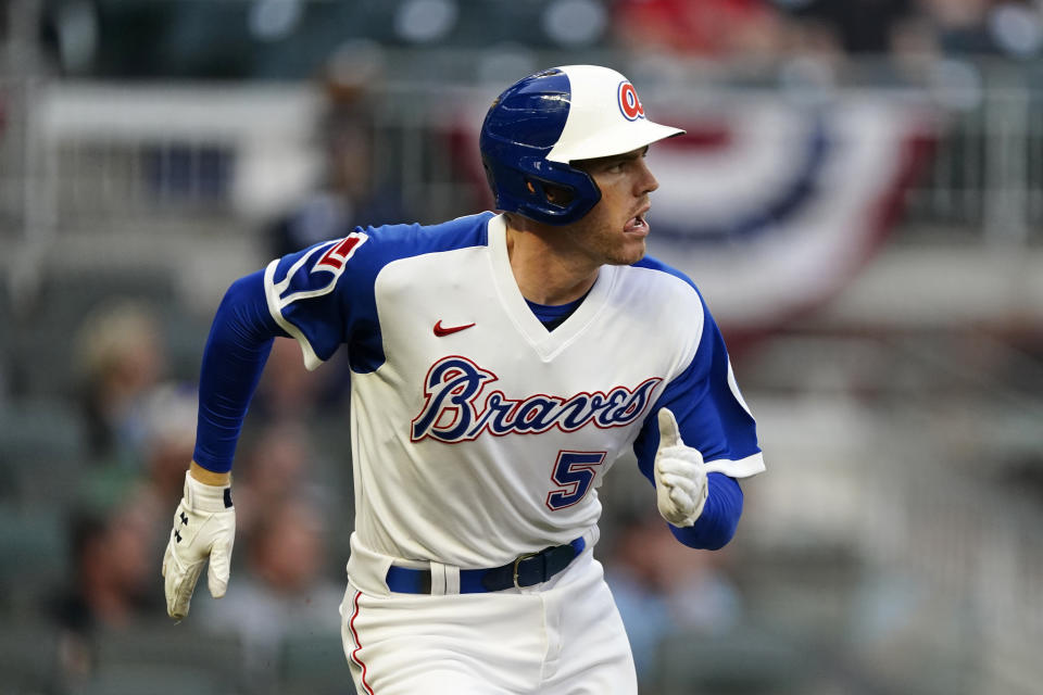 Atlanta Braves' Freddie Freeman runs to first after hitting a double in the first inning against the Miami Marlins in a baseball game Tuesday, April 13, 2021, in Atlanta. (AP Photo/John Bazemore)