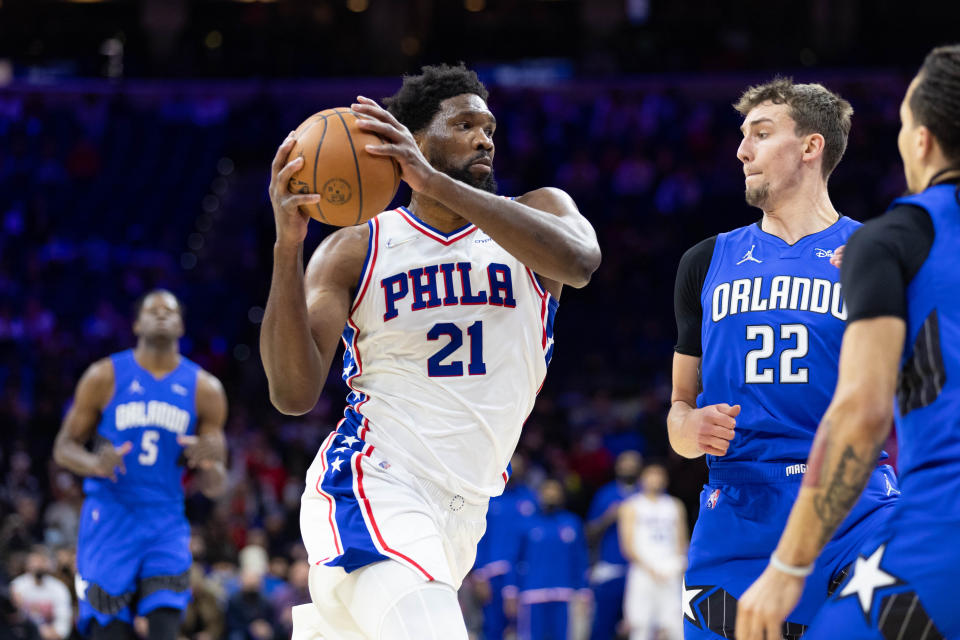 Jan 19, 2022; Philadelphia, Pennsylvania, USA; Philadelphia 76ers center Joel Embiid (21) drives against Orlando Magic forward Franz Wagner (22) during the first quarter at Wells Fargo Center. Mandatory Credit: Bill Streicher-USA TODAY Sports