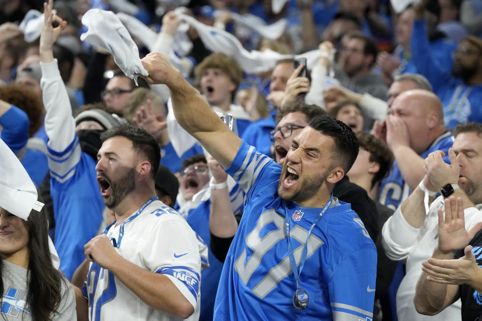 Spectators react during the second half of an NFL football NFC divisional playoff game between the Detroit Lions and the Tampa Bay Buccaneers, Sunday, Jan. 21, 2024, in Detroit. (AP Photo/Carlos Osorio)