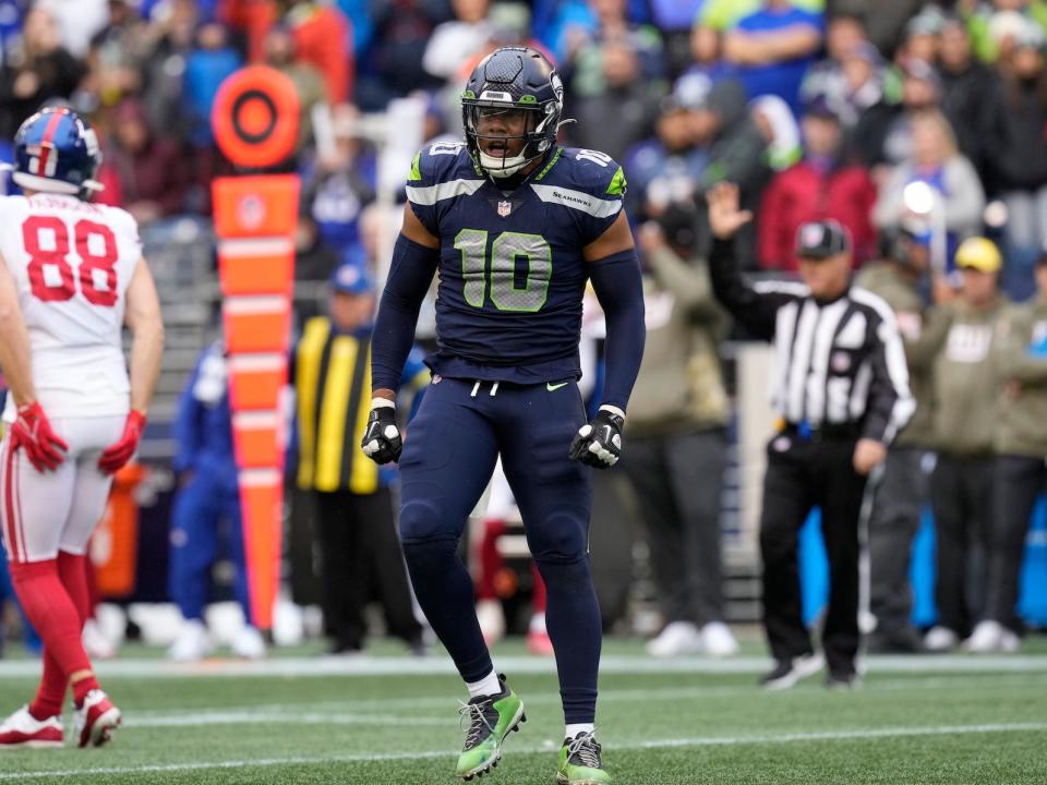 Uchenna Nwosu yells and celebrates during a Seahawks game against the Giants.