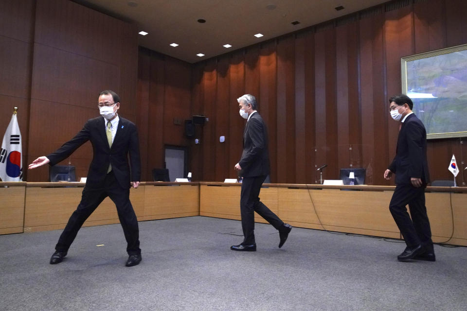 Japanese Foreign Ministry's Director-General of the Asian and Oceanian Affairs Bureau Takehiro Funakoshi, left, escorts U.S. Special Representative for North Korea, Sung Kim, center, and South Korea's Special Representative for Korean Peninsula Peace and Security Affairs Noh Kyu-duk for a photo session during their trilateral meeting on North Korea at Foreign Ministry Tuesday, Sept. 14, 2021 n Tokyo. (AP Photo/Eugene Hoshiko)