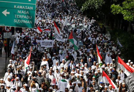 Members of the Islamic Defenders Front (FPI) march to the Indonesia police headquarter during a protest near Sudirman Business District area in Jakarta, Indonesia, January 23, 2017. REUTERS/Beawiharta