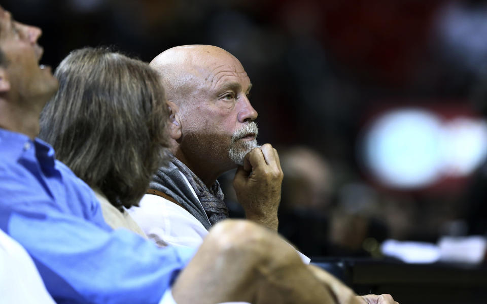 Actor John Malkovich watches game action during the first half of a NBA basketball game between the San Antonio Spurs and Miami Heat in Miami, Sunday, Jan. 26, 2014. (AP Photo/J Pat Carter)