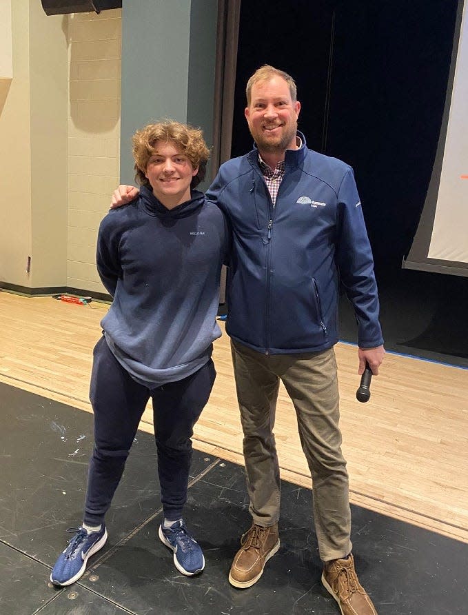 Licking Heights junior Richard Hill, left, won the first grant from Illuminate USA, a Pataskala-based solar panel manufacturer.  Eric Heis, director of public relations for Illuminate USA, presented Hill with the scholarship at the high school's Career Xpress event in March.