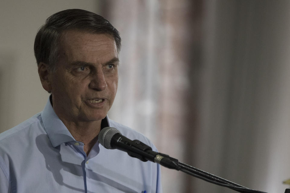 Brazil's President-elect Jair Bolsonaro speaks during a press conference at the 1st Naval District in Rio de Janeiro, Brazil, Friday, Nov. 16, 2018. On Wednesday, Cuba said it was recalling its 8,332 doctors taking part in the "More Doctors" program after Bolsonaro said it could only continue if doctors directly received their salaries from Brazil and were able to bring their families with them. The country will soon start selecting Brazilian doctors to replace the more than 8,000 Cuban doctors working in areas where medical services and physicians are scarce. (AP Photo/Leo Correa)