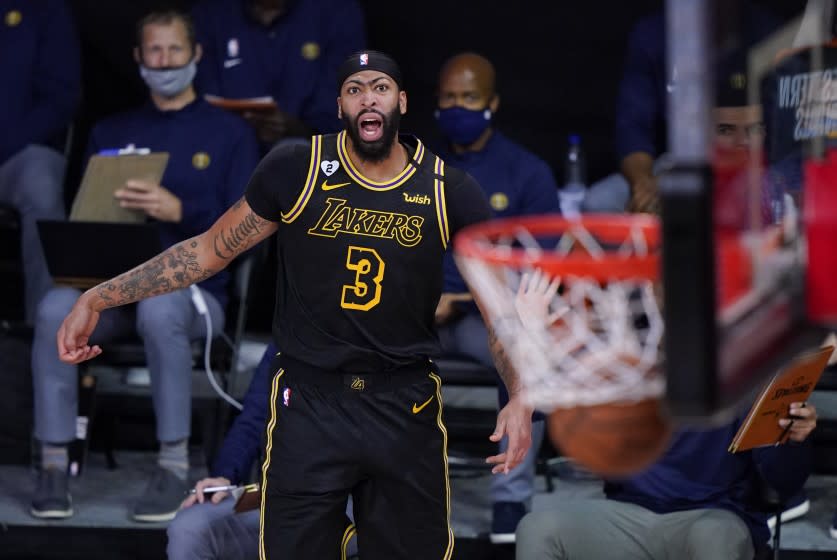 Los Angeles Lakers' Anthony Davis (3) reacts after making a 3-point basket during the second half of an NBA conference final playoff basketball game against the Denver Nuggets Sunday, Sept. 20, 2020, in Lake Buena Vista, Fla. (AP Photo/Mark J. Terrill)