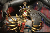 WEST BENGAL, INDIA - 2020/10/12: West Bengal Chief Minister Mamata Banerjee visits Durga Puja pandal at Chetla Agrani Club and paints an eye of an idol of Goddess Durga in Kolkata. Banerjee, who was speaking after a cabinet meeting, said I ask everybody to follow the COVID-19 safety protocols during the festive season. There are instance of community transmission of COVID-19 and also the contagion becoming air borne.. (Photo by Dipa Chakraborty/Pacific Press/LightRocket via Getty Images)