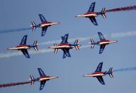 French aircrafts of the Patrouille de France spray colored smoke during a performance on the opening day of the Dubai Airshow in Dubai, United Arab Emirates, Sunday, Nov. 17, 2019. (AP Photo/Kamran Jebreili)