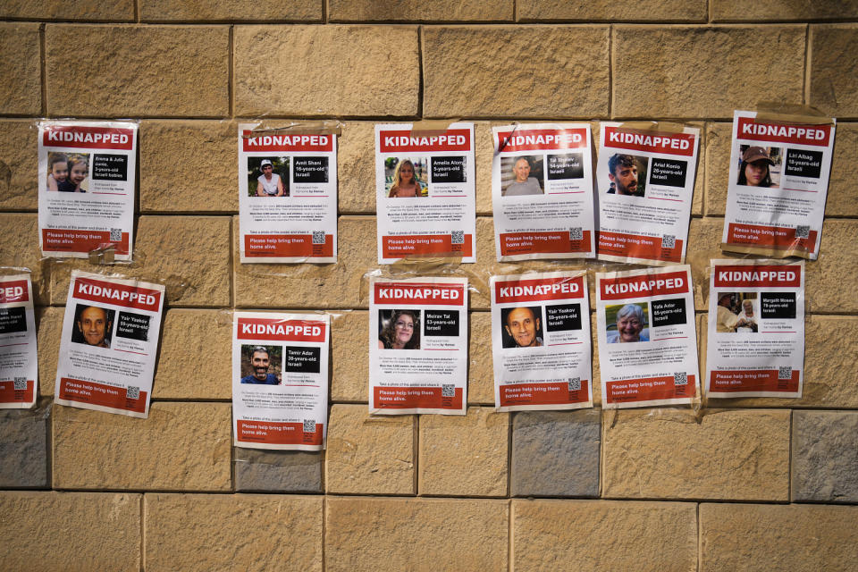 Photographs of people who were abducted during the Hamas attack (Francisco Seco / AP)