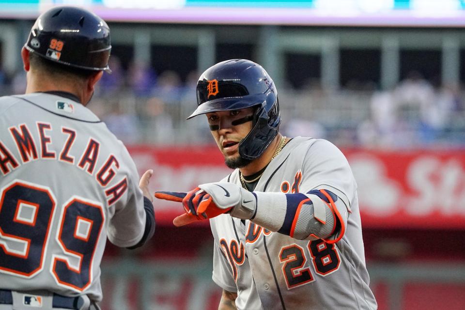 Detroit Tigers shortstop Javier Baez (28) celebrates with first base coach Alfredo Amezaga (99) against the Kansas City Royals after hitting a one-run single in the fifth inning at Kauffman Stadium in Kansas City, Missouri, on Tuesday, May 23, 2023.