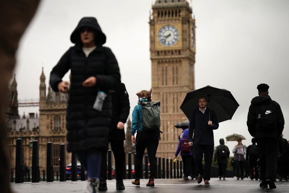 Commuters with umbrellas on a rainy morning in Westminster, London. (PA)