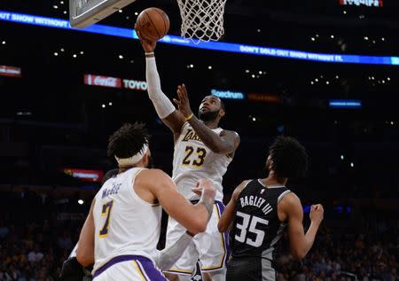 March 24, 2019; Los Angeles, CA, USA; Los Angeles Lakers forward LeBron James (23) moves to the basket against Sacramento Kings forward Marvin Bagley III (35) during the second half at Staples Center. Mandatory Credit: Gary A. Vasquez-USA TODAY Sports