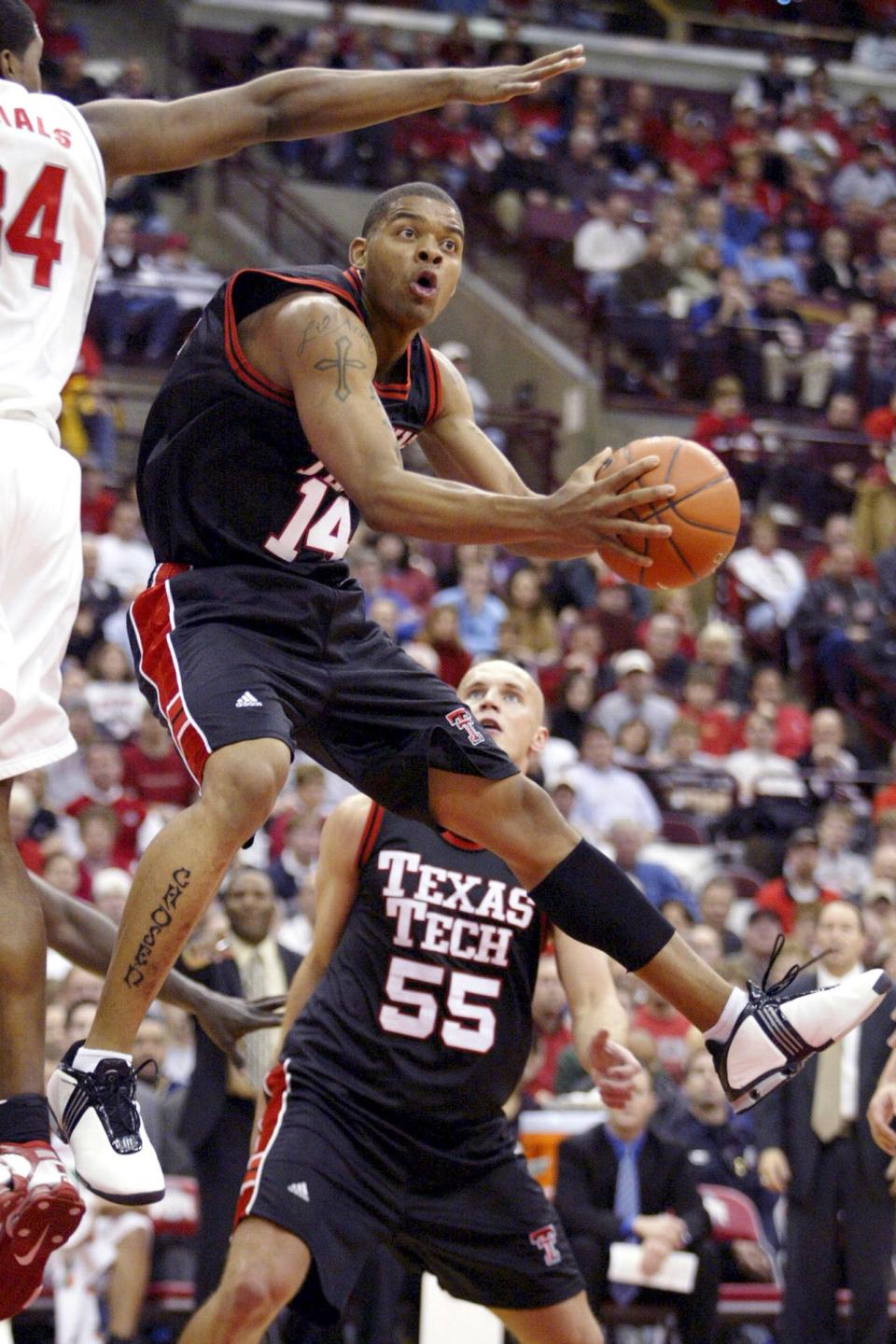 In this Jan 4, 2004, file photo, Texas Tech's Andre Emmett (14) tries to shoot around Ohio State's Terence Dials during he NCAA basketball game at Value City Arena in Columbus, Ohio.