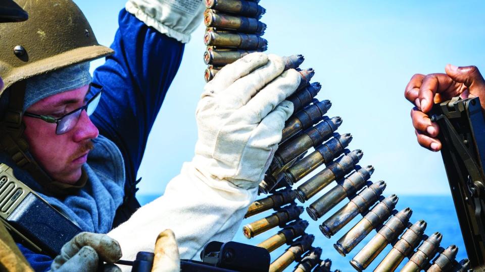 Gunner’s Mate 3rd Class Travis Lemke, assigned to the guided-missile destroyer Porter, loads simulated rounds into an M2A1 .50 caliber machine gun to prepare for a simulated strait transit as part of Large Scale Exercise 2023. (IC3 Hailey Servedio/Navy)