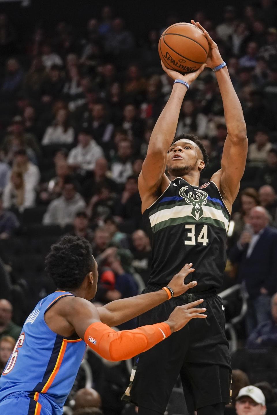 Milwaukee Bucks' Giannis Antetokounmpo shoots over Oklahoma City Thunder's Hamidou Diallo during the second half of an NBA basketball game Friday, Feb. 28, 2020, in Milwaukee. (AP Photo/Morry Gash)