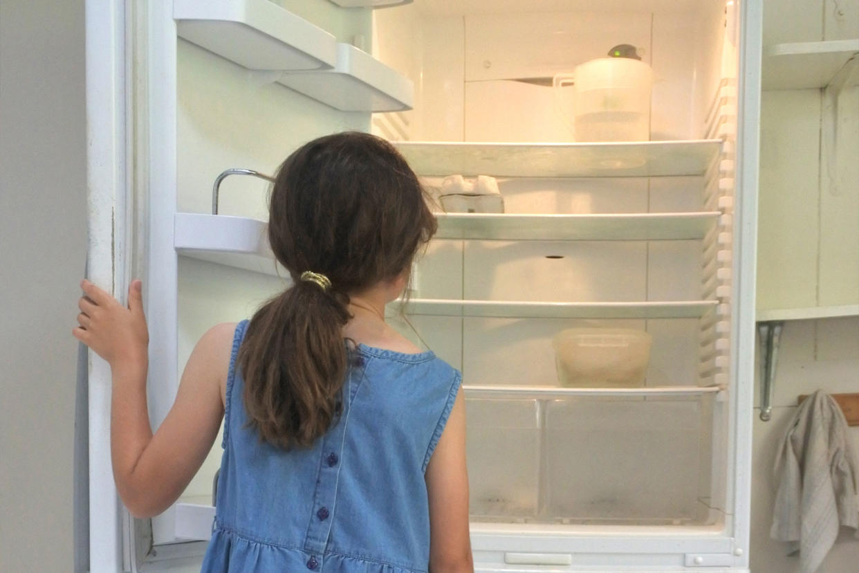 Hungry girl looks for food in empty fridge at home Getty Images/Rafael Ben-Ari