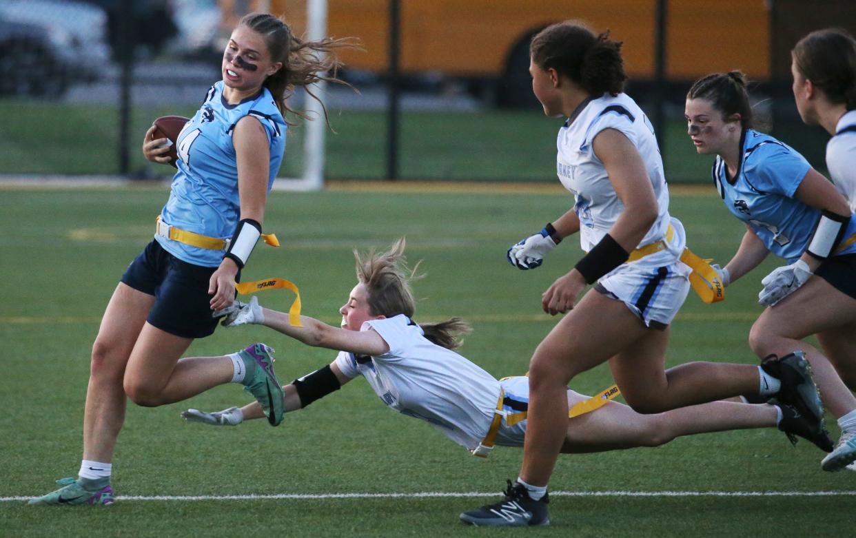 Kearney's Lillian Ilardo dives but misses the flag of Gananda quarterback Ella Lathrop.