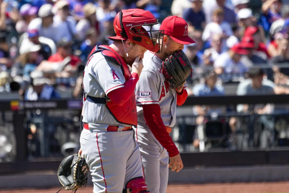 Los Angeles Angels catcher Chad Wallach, left, and pitcher Griffin Canning attend a mound conference in the sixth inning of a baseball game, Sunday, Aug. 27, 2023, in New York. (AP Photo/Mary Altaffer)