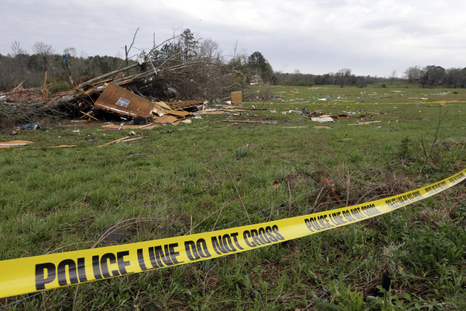 Police tape lines the yard where James Geno "JW" was killed after a tornado touched down on Friday, March 26, 2021 in Wellington, Ala. A tornado outbreak has ripped across the Deep South leaving paths of destruction. (AP Photo/Butch Dill)