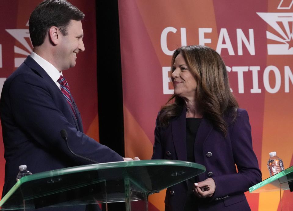 Democratic Congressional District 1 candidates Andrei Cherny and Marlene Galán-Woods shake hands before debating at BitFire Studio in Phoenix on May 15, 2024.