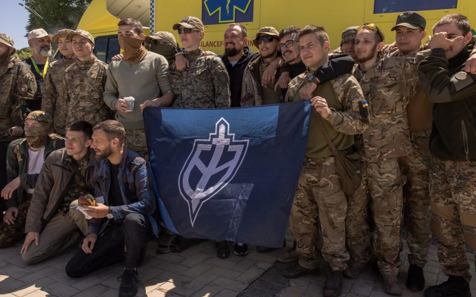 Members of The Russian Volunteer Corps, the Russian anti-government group that is fighting on Ukraine's side, pose for photos during a donation event - Getty