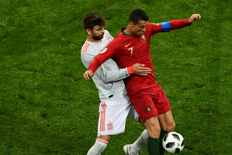 Spain's Gerard Pique challenging Portugal's Cristiano Ronaldo in the 3-3 World Cup draw