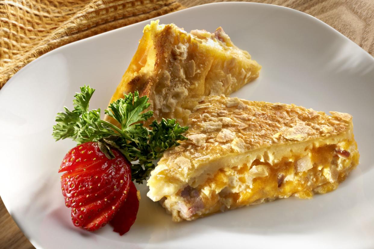 Eggs, ham, cheddar cheese and saute onion and saltines are layered and  baked into a breakfast casserole.