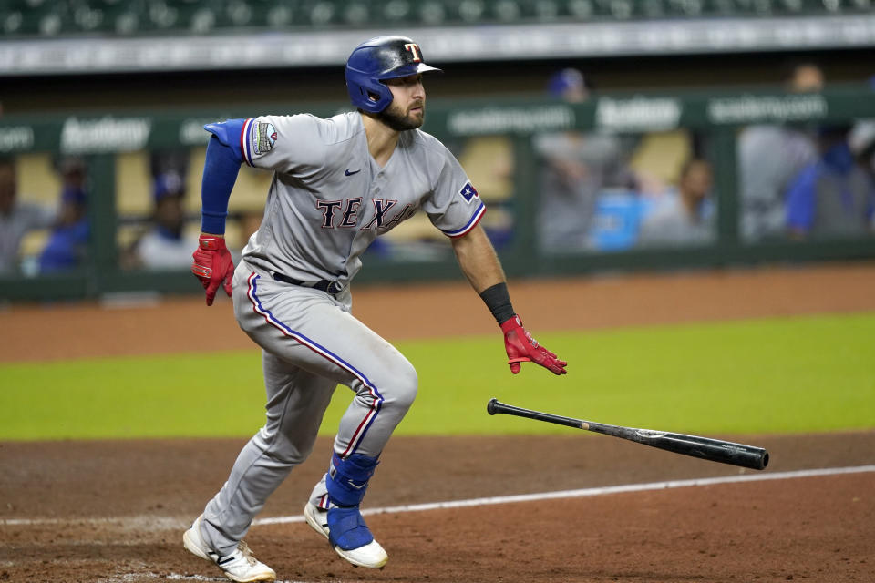 Texas Rangers' Joey Gallo drops his bat after hitting a RBI ground-rule double against the Houston Astros during the ninth inning of a baseball game Wednesday, Sept. 16, 2020, in Houston. (AP Photo/David J. Phillip)