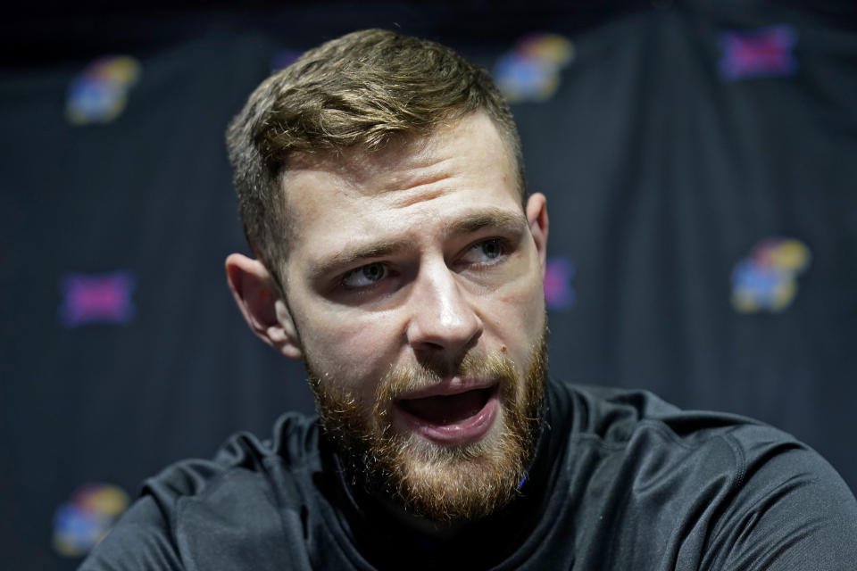 Kansas' Hunter Dickinson talks to the media during the NCAA college Big 12 men's basketball media day Wednesday, Oct. 18, 2023, in Kansas City, Mo. (AP Photo/Charlie Riedel)