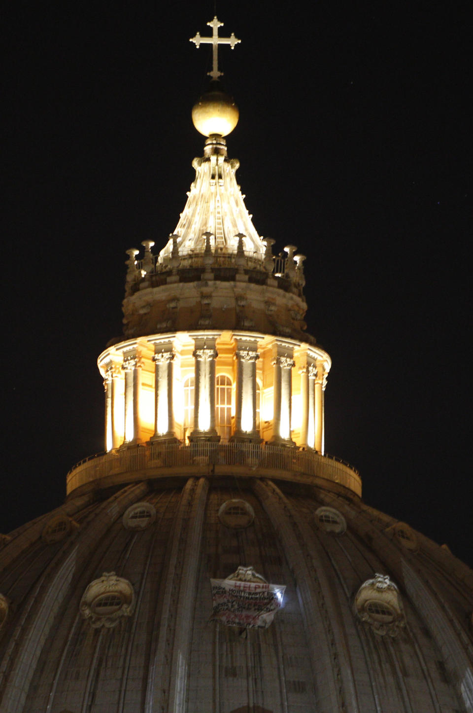 A banner protesting Italian Premier Mario Monti, Europe and multinationals hangs from a window of St. Peter's dome at the Vatican, Tuesday, Oct. 2, 2012. (AP Photo / Alessandra Tarantino)