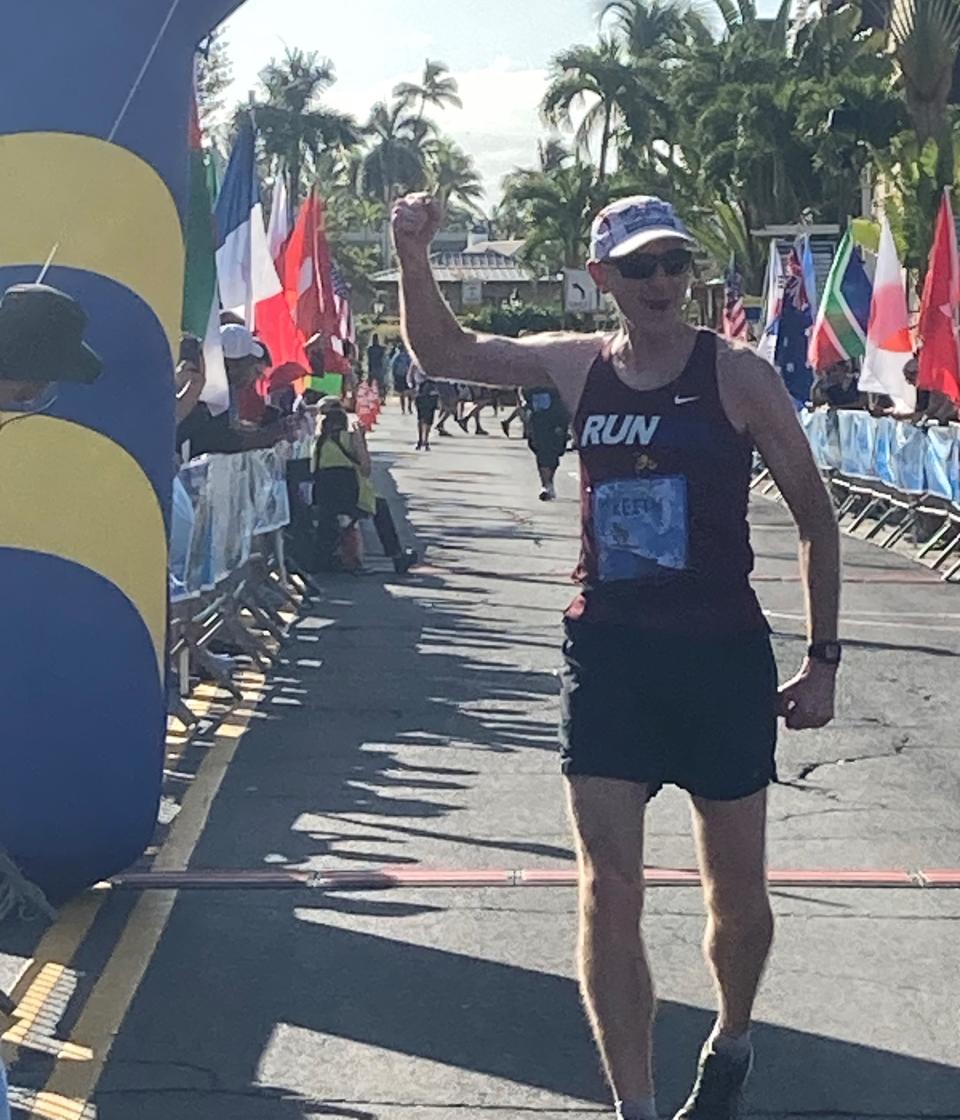 Keith Tindall exults as he crosses the finish line of the Maui Oceanfront Marathon on January 15. That gave him completed 26.2-mile marathons in each of the 50 states.