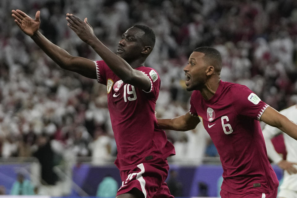 Qatar's Almoez Ali, left, celebrates with teammates after scoring during the Asian Cup semifinal soccer match between Qatar and Iran at Al Thumama Stadium in Doha, Qatar, Wednesday, Feb. 7, 2024. At right is Qatar's Abdel Aziz Hatim.(AP Photo/Thanassis Stavrakis)