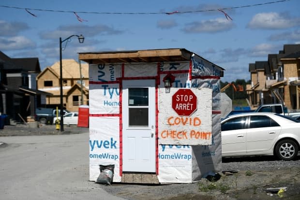 A COVID-19 checkpoint is seen at a work site entrance to a new subdivision in Kanata last week.  (Justin Tang/The Canadian Press - image credit)