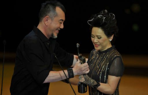 Hong Kong actress Deanie Ip (R) is presented the Best Actress award by Hong Kong actor Anthony Wong at the 31st Hong Kong Film Awards. A heart-warming drama film, "A Simple Life", depicting the relationship between an elderly loyal servant and her young master swept all the major categories of the Hong Kong Film Awards on Sunday