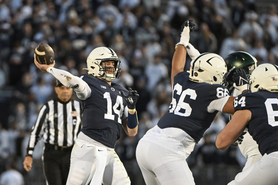 Penn State quarterback Sean Clifford (14) looks to throw a pass during the first half of an NCAA college football game against Michigan State, Saturday, Nov. 26, 2022, in State College, Pa. (AP Photo/Barry Reeger)