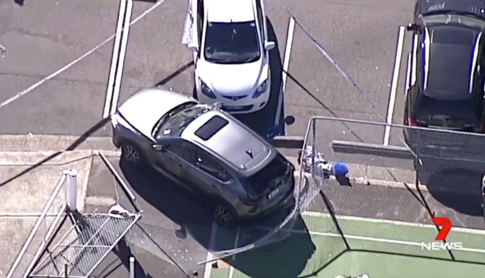 The driver accidentally rammed into the couple, trapping the woman under her car. Source: 7News