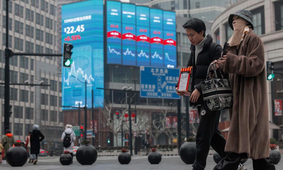 <span>Economic data on display in Beijing; China’s wealthy middle class has a lot of money to invest, and not many outlets for it.</span><span>Photograph: Alex Plavevski/EPA</span>