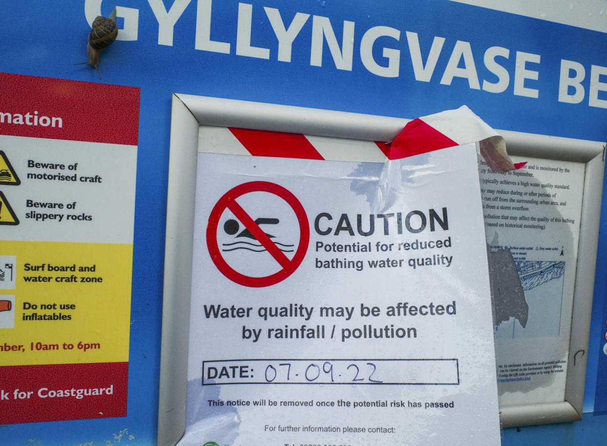 FALMOUTH - SEPTEMBER 08: A sign from the Environment Agency warns bathers of potential ongoing sea water pollution at Gyllyngvase Beach on September 08, 2022 in Falmouth, Cornwall, England. The environmental group, Surfers Against Sewage, has also issued notices concerning twelve Cornish beaches, including Gyllyngvase, warning of  sewage discharges into the sea. (Photo by Hugh R Hastings/Getty Images)