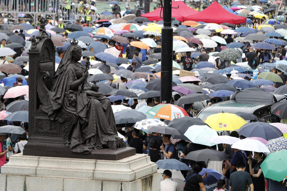 Protesters gather near a statue of Queen Victoria at Victoria Park in Hong Kong Sunday, Aug. 18, 2019. A spokesman for China's ceremonial legislature condemned statements from U.S. lawmakers supportive of Hong Kong's pro-democracy movement, as more protests were planned Sunday following a day of dueling rallies that highlighted the political divide in the Chinese territory. (AP Photo/Vincent Thian)