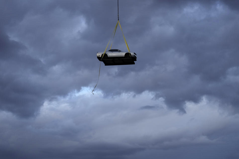 A helicopter transports the 2023 Challenger SRT Demon 170 during an event to unveil the car Monday, March 20, 2023, in Las Vegas. (AP Photo/John Locher)